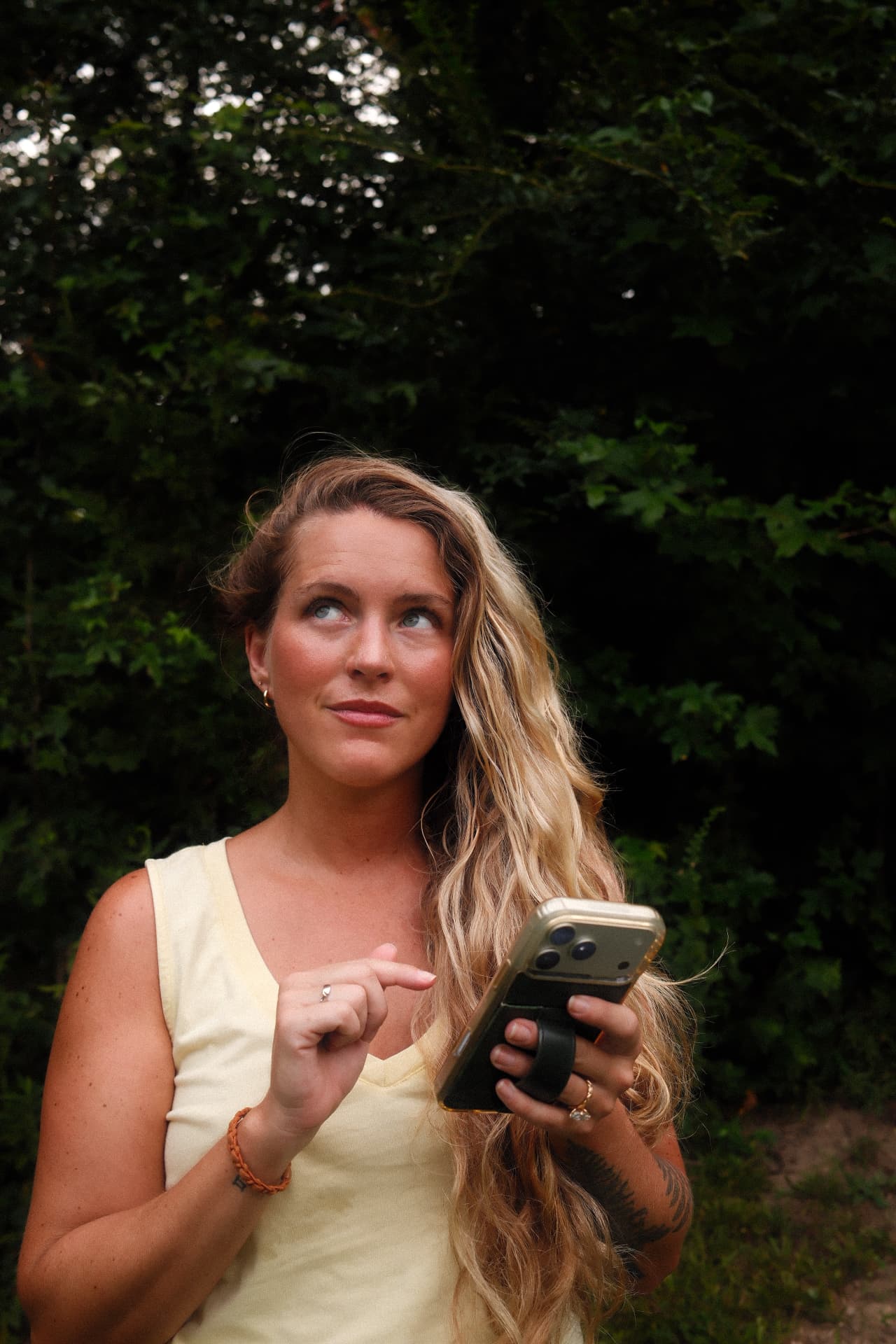Creator holding a phone outdoors